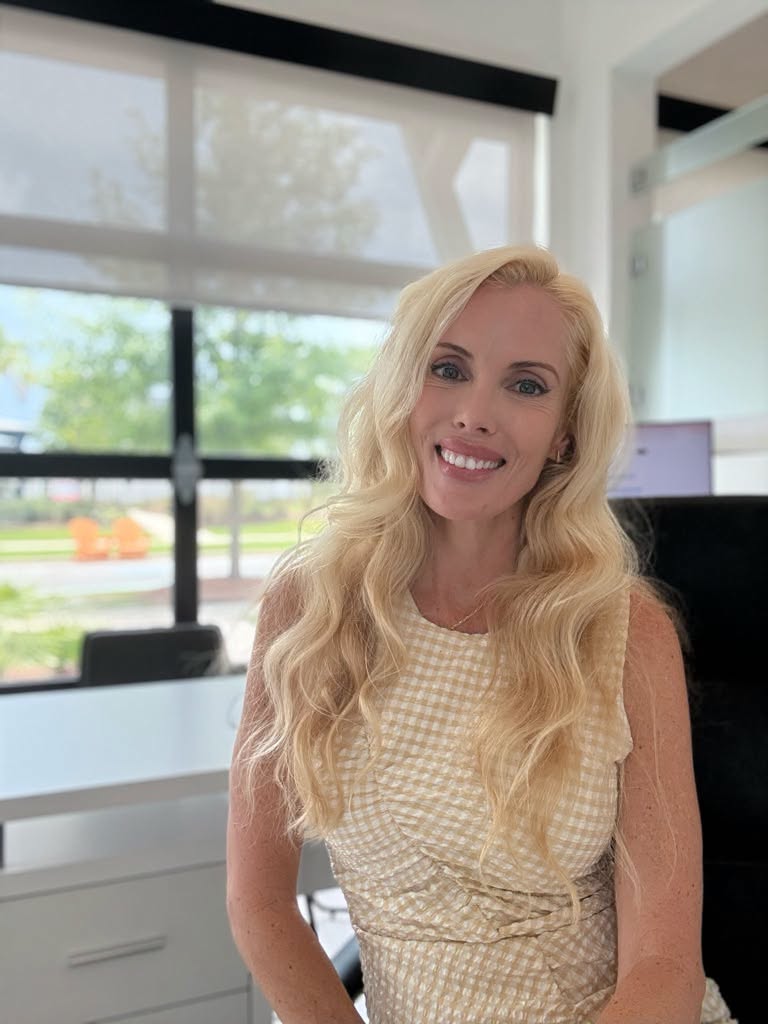 Erica Joy smiling at her desk in the Midtown at Nexton sales office